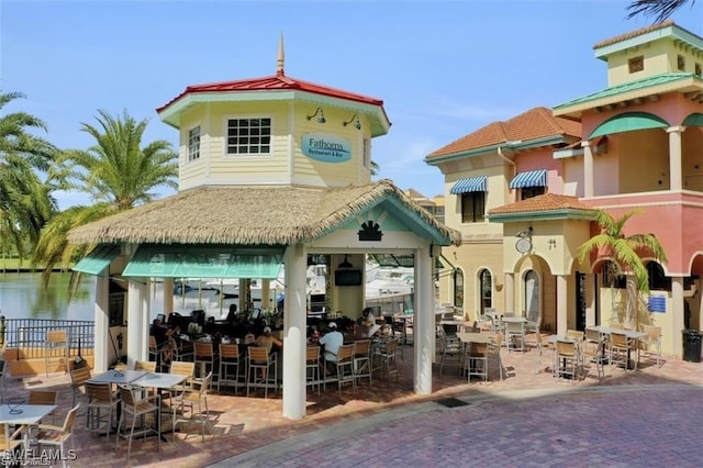 view of home's community featuring a water view and a patio area