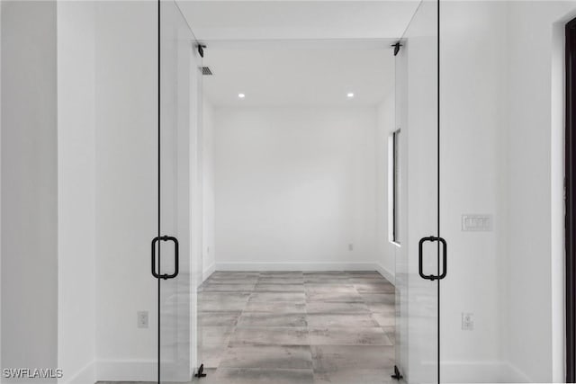 bathroom featuring a stall shower, baseboards, and recessed lighting