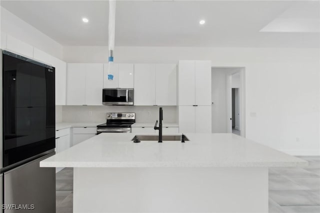 kitchen with white cabinets, modern cabinets, stainless steel appliances, and a sink