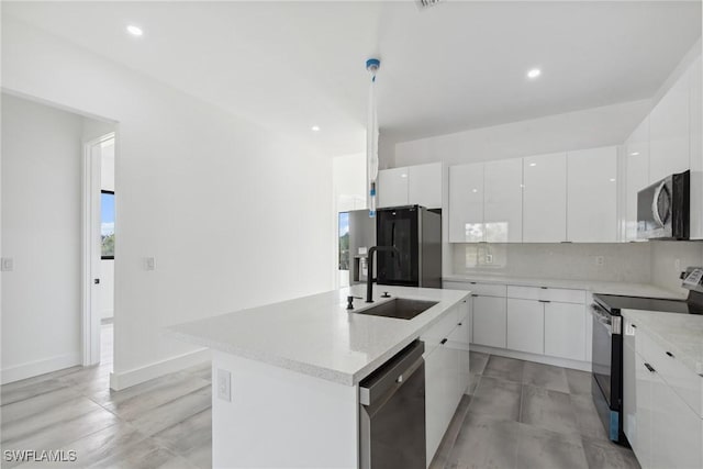 kitchen featuring modern cabinets, appliances with stainless steel finishes, white cabinets, and a sink