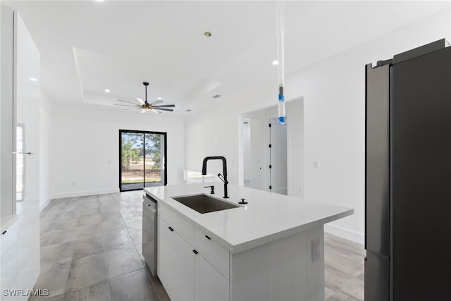 kitchen with a sink, white cabinetry, stainless steel dishwasher, modern cabinets, and a raised ceiling