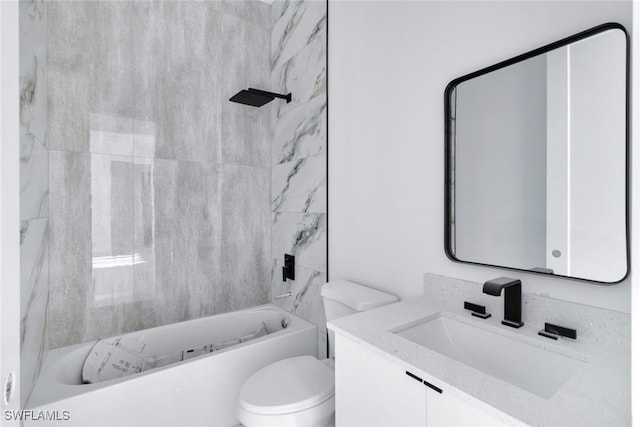 full bathroom featuring tiled shower / bath, vanity, and toilet