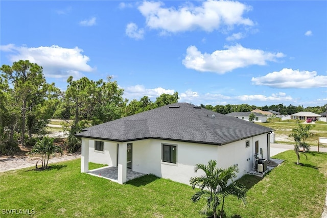 back of property featuring a lawn and a patio