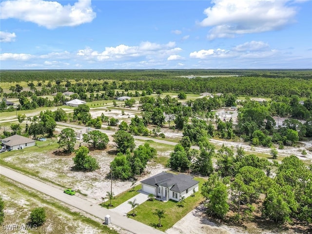 drone / aerial view featuring a wooded view