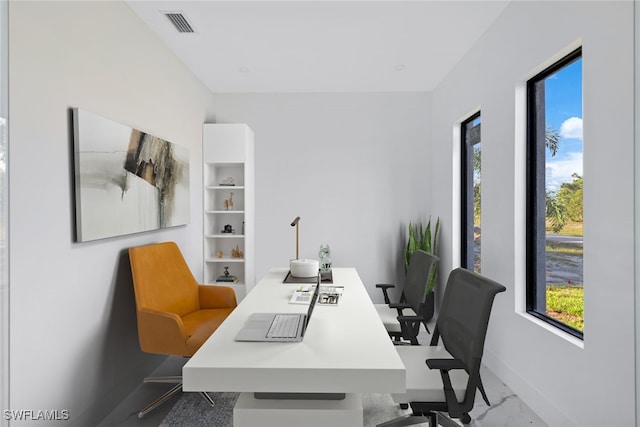 office space featuring marble finish floor, visible vents, and baseboards