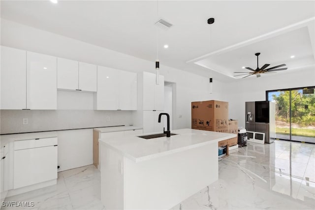 kitchen featuring marble finish floor, visible vents, white cabinets, a sink, and modern cabinets