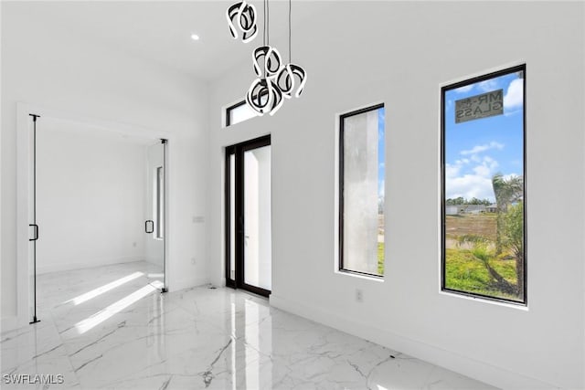 interior space with marble finish floor, recessed lighting, and baseboards