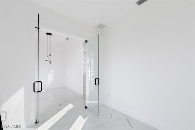 bathroom featuring marble finish floor, visible vents, and a marble finish shower