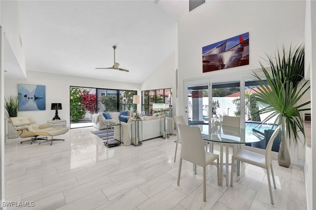 dining space with high vaulted ceiling, a wealth of natural light, and ceiling fan