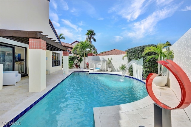 view of swimming pool featuring pool water feature and a patio area