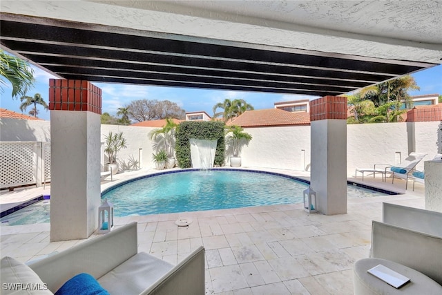 view of swimming pool featuring pool water feature and a patio area