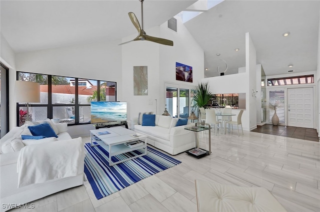 living room with high vaulted ceiling and ceiling fan