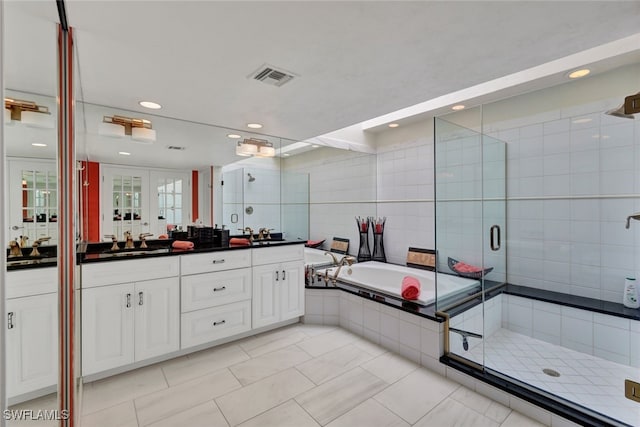 bathroom with vanity, tile walls, and shower with separate bathtub