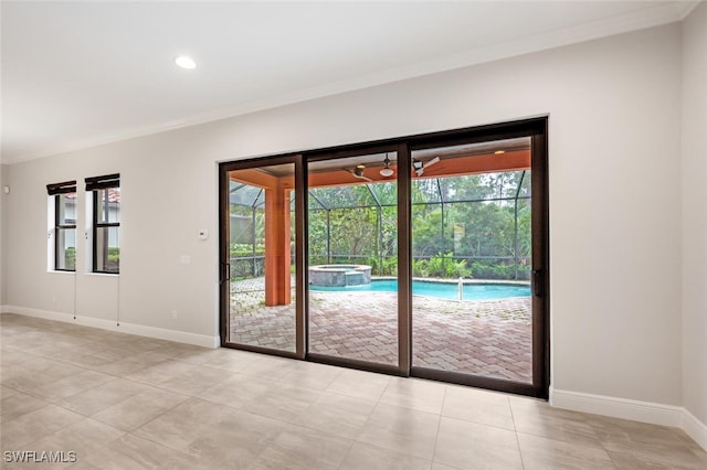 entryway featuring light tile patterned flooring and ornamental molding