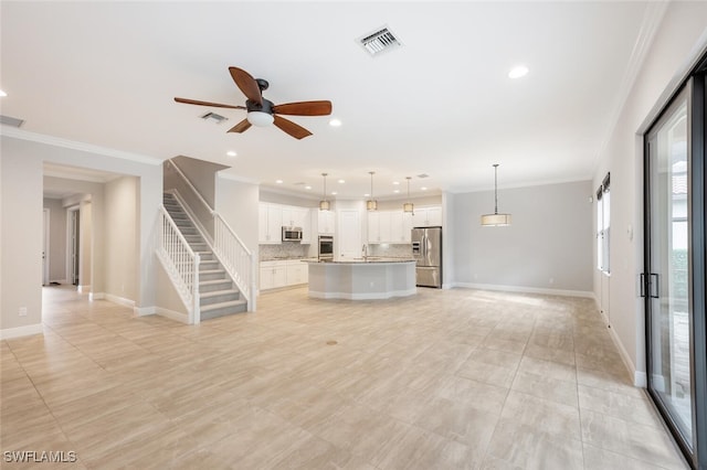 unfurnished living room featuring sink, ceiling fan, light tile patterned flooring, and crown molding