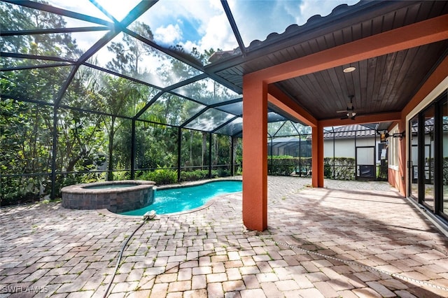 view of pool with ceiling fan, glass enclosure, an in ground hot tub, and a patio