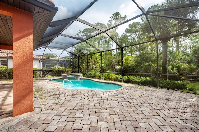 view of pool with a patio and a lanai