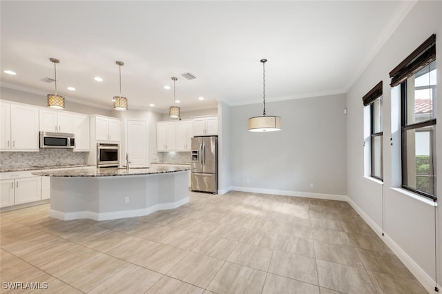 kitchen featuring decorative backsplash, appliances with stainless steel finishes, a healthy amount of sunlight, and light stone countertops