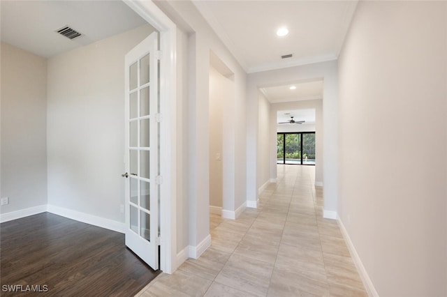 hallway with light hardwood / wood-style flooring and french doors