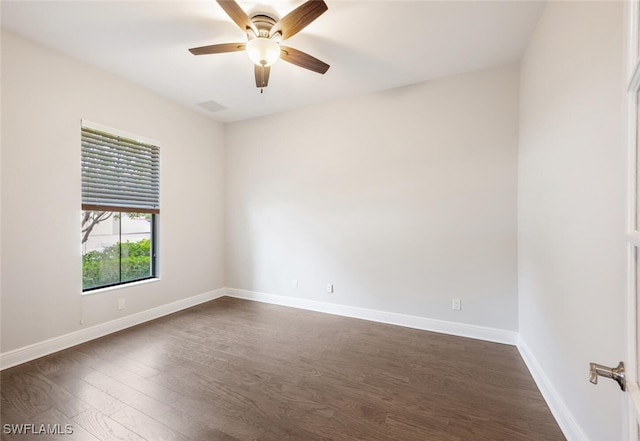 empty room featuring ceiling fan and dark wood-type flooring