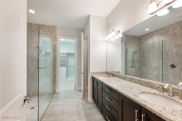 bathroom with an enclosed shower, vanity, and tile patterned floors