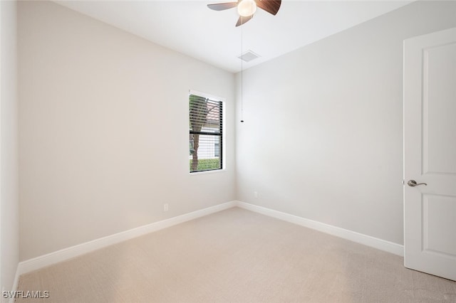 unfurnished room with ceiling fan and light carpet