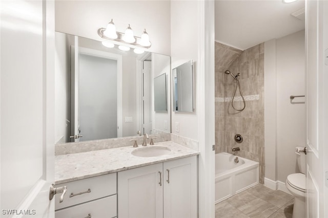 full bathroom featuring toilet, tiled shower / bath combo, vanity, and tile patterned floors