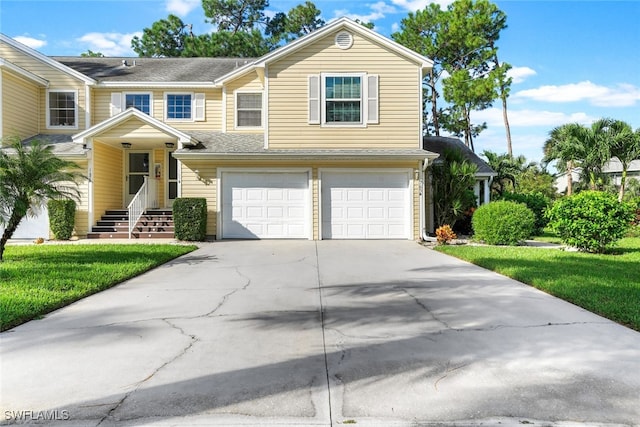 view of front of property featuring a garage and a front lawn