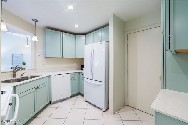 kitchen featuring sink, pendant lighting, white appliances, and light tile patterned floors