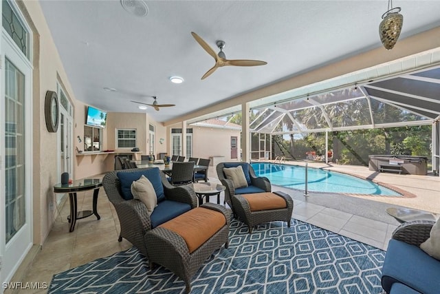 outdoor pool featuring a hot tub, a patio, ceiling fan, a lanai, and an outdoor living space