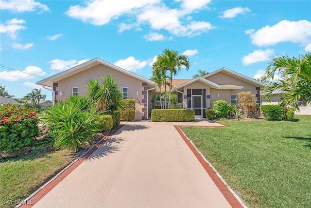 single story home with stucco siding and a front yard