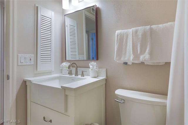 bathroom with toilet and vanity