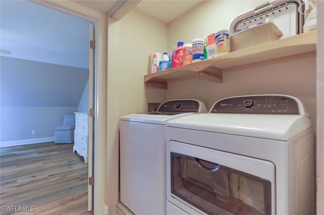 washroom with light hardwood / wood-style floors and independent washer and dryer