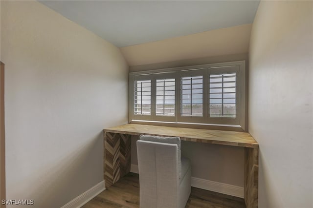 unfurnished office featuring lofted ceiling and dark hardwood / wood-style flooring