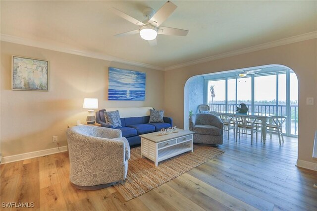 living room with ceiling fan, light hardwood / wood-style flooring, and crown molding