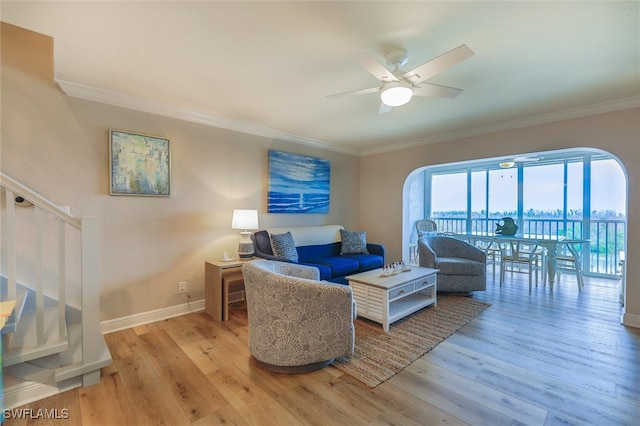 living room with ceiling fan, light hardwood / wood-style flooring, and ornamental molding