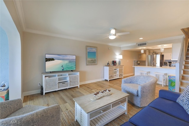 living room with ceiling fan, light hardwood / wood-style floors, and ornamental molding