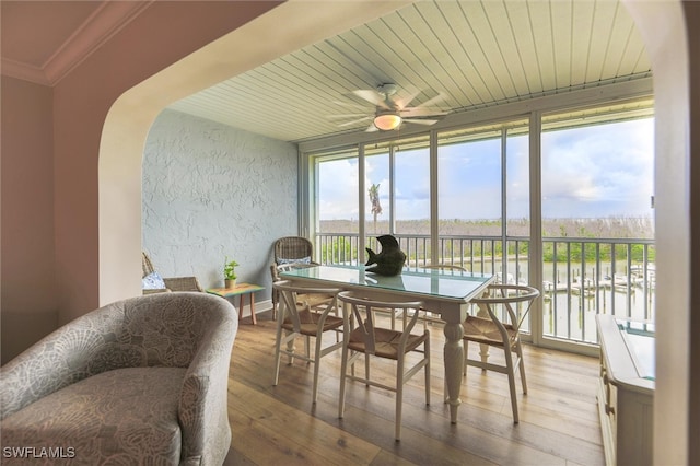 sunroom / solarium with ceiling fan and wood ceiling