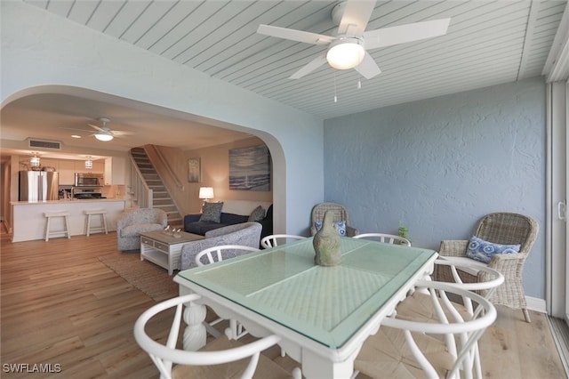 dining space featuring light wood-type flooring and ceiling fan