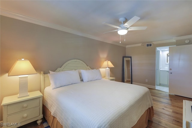 bedroom with ceiling fan, hardwood / wood-style flooring, crown molding, and ensuite bathroom