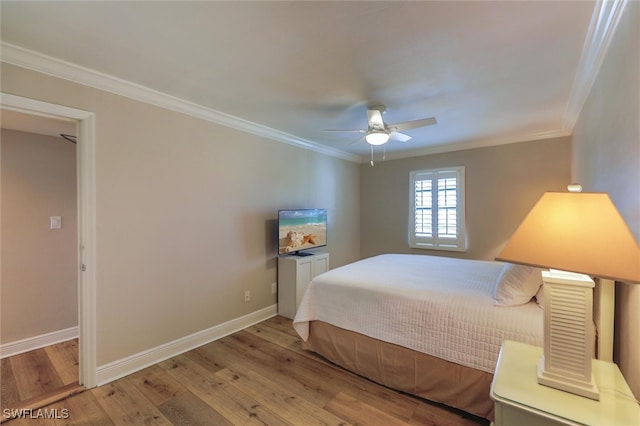 bedroom featuring ceiling fan, light hardwood / wood-style flooring, and crown molding