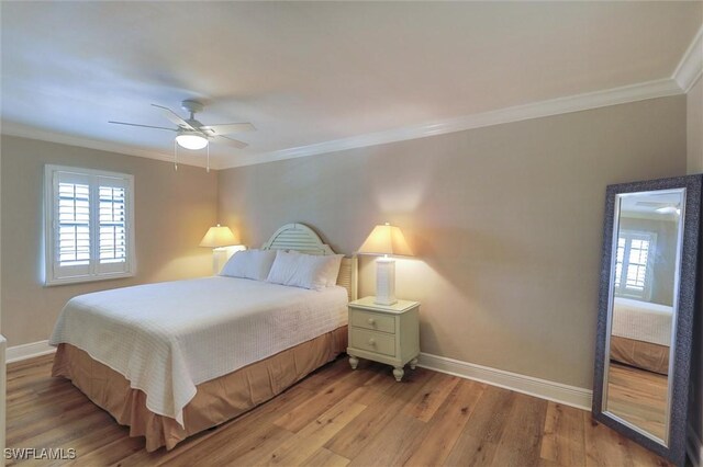 bedroom with ceiling fan, hardwood / wood-style floors, and ornamental molding