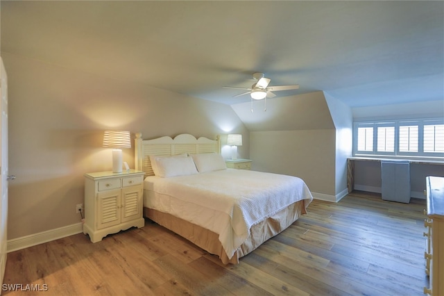 bedroom with light wood-type flooring, ceiling fan, and lofted ceiling