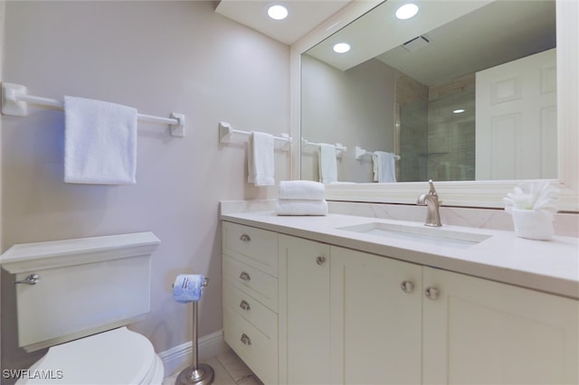 bathroom with toilet, tile patterned flooring, and vanity