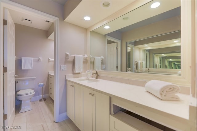 bathroom with tile patterned floors, vanity, and toilet