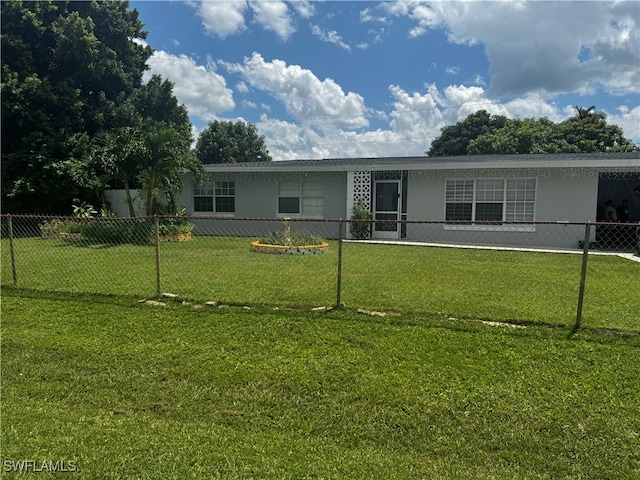 rear view of property with a yard