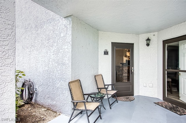 entrance to property with stucco siding