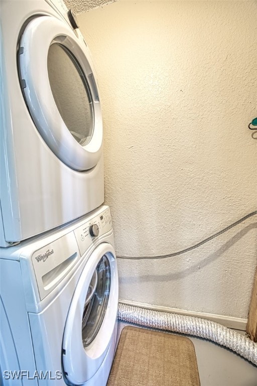 laundry room with stacked washing maching and dryer