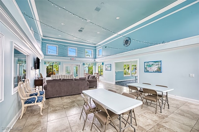 tiled dining space featuring plenty of natural light, french doors, and a high ceiling