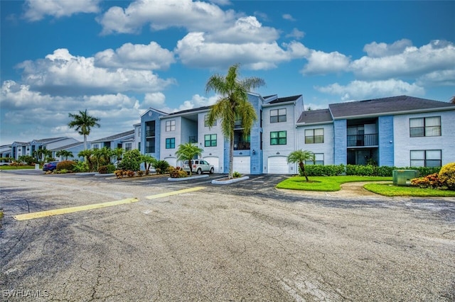 view of front of home with a balcony and a garage